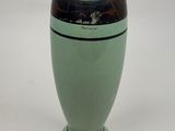 a green vase with a black stripe on it