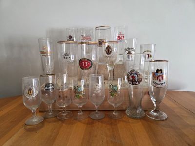a lot of wine glasses sitting on a wooden table