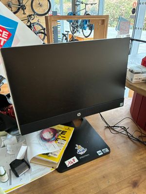 a computer monitor sitting on top of a wooden desk