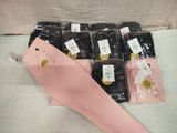 several pairs of pink pants sitting on top of a bed next to each other