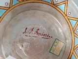 a glass bowl with a label on it sitting on a table