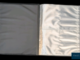 a silver folder that is open on a black background