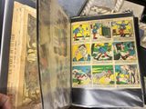 someone is holding a comic book open on a table