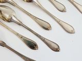 a lot of silver spoons and spoon spoons on a table