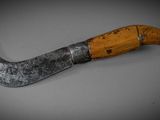 an old knife with a wooden handle on a table