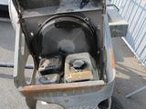a metal cart with a bunch of items inside of it