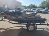 a picture of a jet ski trailer parked in a parking lot