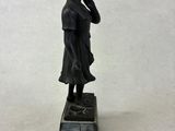 bronze statue of a boy on a marble base