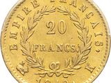 a close up of a gold coin with a wreath on it