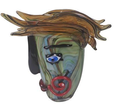 a glass sculpture of a woman ' s face on a wall