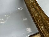 a gold spoon sitting on top of a white plate