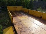 a yellow truck that is parked on the side of the road