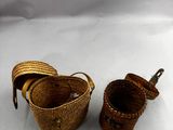 two baskets with handles and handles are sitting on a white surface