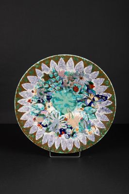 a green plate with flowers and leaves on it