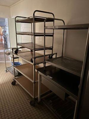 a bunk bed in the middle of a room with a metal shelf