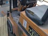 a forklift that is parked next to a pile of trash