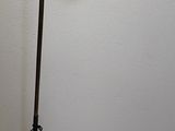 a lamp that is on a tripod stand in a room