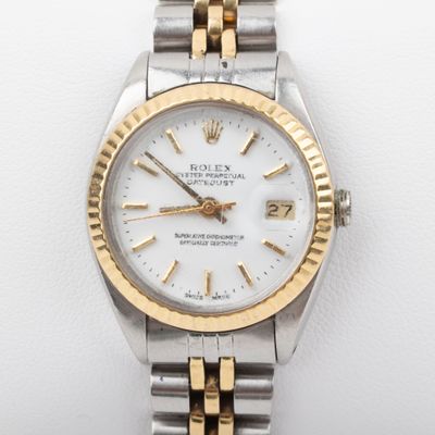 a close up of a wrist watch on a white surface