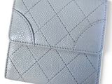 a close up of a wallet on a white surface with a white background