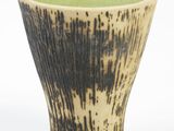 a close up of a cup with a black and white design