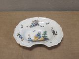 a plate with a bird on it sitting on a table