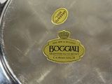a metal pan with a logo on it sitting on a counter