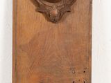 carved wooden plaque with a woman ' s head on it