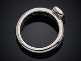 a close up of a ring on a black surface with a black background