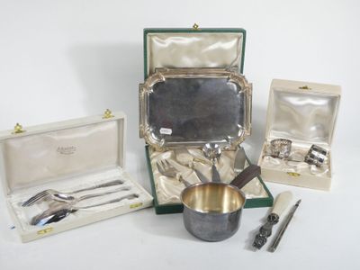 a silverware set in a case with a silver spoon and a silver cup