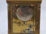 a gold clock that is sitting on a table