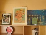 a shelf with pictures and a clock on top of it