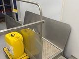 a yellow gas can sitting on the floor next to a ramp