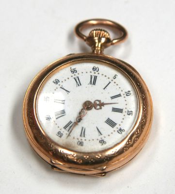 a gold pocket watch with roman numerals on it