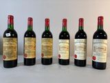 six bouteilles de vin sont alignées sur une table