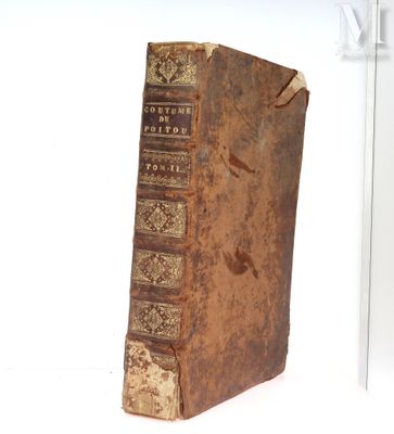 an old book sitting on top of a white table