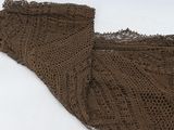 a close up of a piece of lace on a snow covered ground