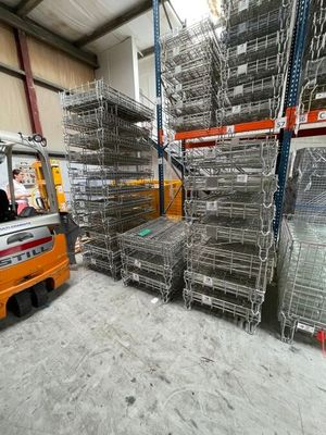 un chariot élévateur garé devant une grande pile de cages