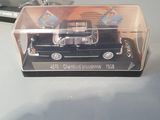 a black toy car in a clear box on a table