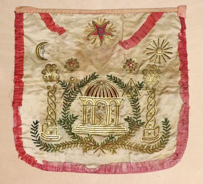an image of a white and red embroidered bag with a birdcage on it