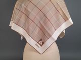 beige and red plaid shawl on a mannequin head