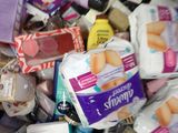many different types of toothpaste in a bin