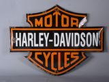 a harley davidson sign on the wall of a garage