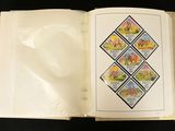an open book with stamps on it on a black surface