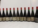 six bottles of wine are lined up in a row on a table