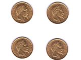 a set of four gold coins with the head of a man and a woman