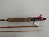 two fishing rods and a fishing rod on a white surface