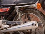 a close up of a motorcycle parked on the side of the street