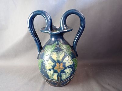a blue vase with a floral design on it
