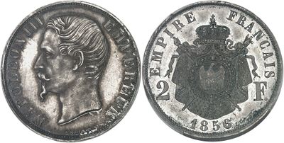 an old silver coin with a woman ' s face and crown on it