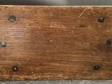 a close up of a piece of wood with rivets on it